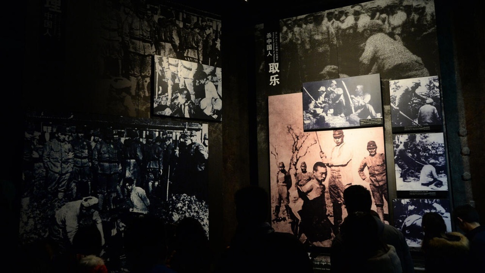 Chinese tourists view photos of Japanese war crimes at the Nanjing Massacre Memorial Museum in Nanjing in 2014 © Mark RALSTON / AFP/File Chinese tourists view photos of Japanese war crimes at the Nanjing Massacre Memorial Museum in Nanjing in 2014 © Mark RALSTON / AFP/File