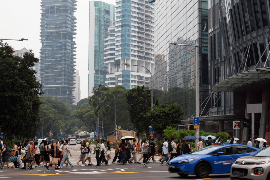 People cross the road as residential and commercial buildings are shrouded by haze in Orchard Road in Singapore, September 15, 2026. REUTERS/Ore Huiying 