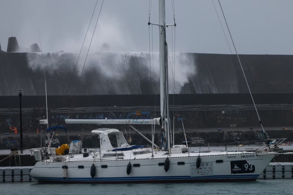 A sailboat is moored near a breakwater as waves generated by Typhoon Champi hit Badouzi Fishing Port in Keelung, Taiwan, October 23, 2026. REUTERS/Ann Wang