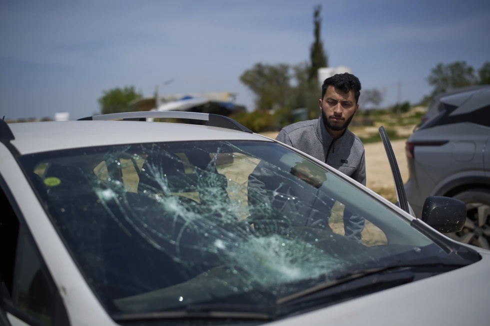 Basel Adra, Palestinian co-director of the Oscar winner documentary “No Other Land”, looks at a damaged car after a settler’s attack in the village of Susiya in Masafer Yatta, south Hebron hills, March 25, 2025. (AP Photo/Leo Correa, file)