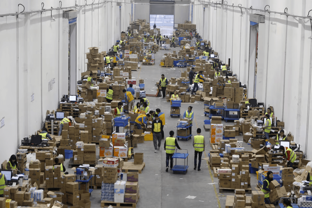Employees sort boxes and parcels at the logistic centre of a express delivery company in Wuhan, Hubei province, China, November 12, 2015. REUTERS/Stringer 