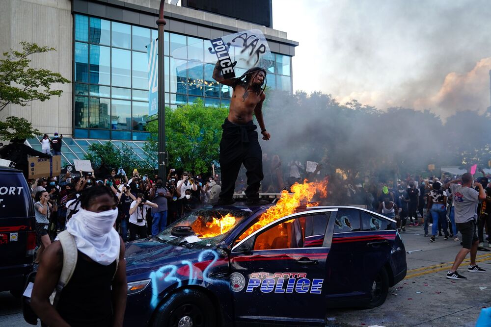 A man stands on top of a burning police car during a protest in Atlanta after George Floyd died in police custody. Photo: AFP. A man stands on top of a burning police car during a protest in Atlanta after George Floyd died in police custody. Photo: AFP.