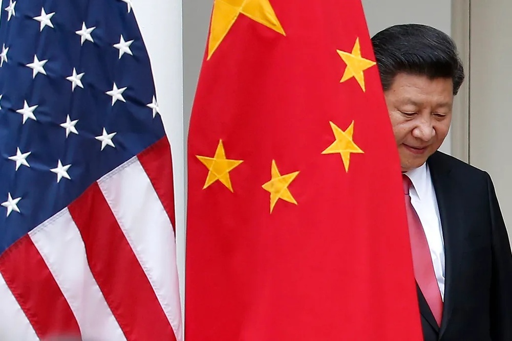 Chinese President Xi Jinping steps out from behind China's flag as he takes his position for a news conference in the Rose Garden of the White House in Washington. ((AP/Evan Vucci)) Chinese President Xi Jinping steps out from behind China's flag as he takes his position for a news conference in the Rose Garden of the White House in Washington. ((AP/Evan Vucci))