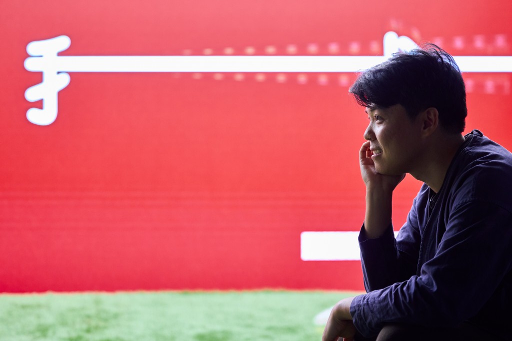 Wong Ping with his work at the Sigg Prize  2025 exhibition 