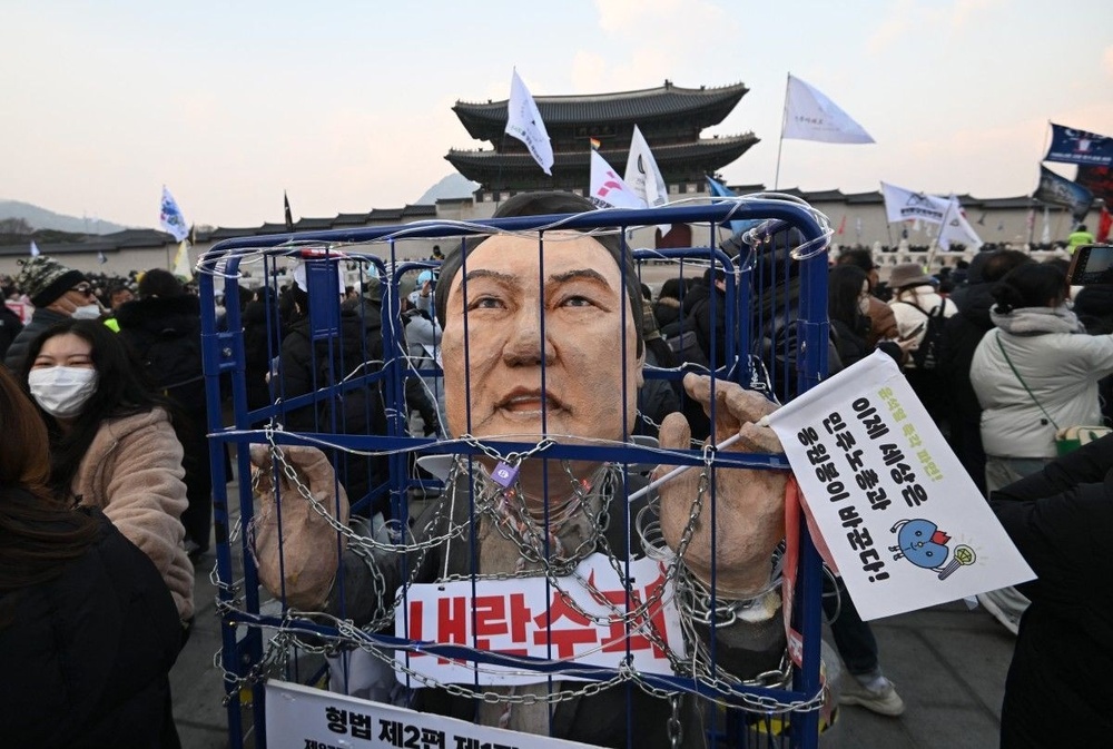 An effigy of South Korea's impeached President Yoon Suk Yeol is seen in a mock prison as protesters take part in a rally calling for Yoon's ouster in front of the Gwanghwamun Gate of Gyeongbokgung Palace in Seoul on December 21, 2024. Jung Yeon-je, AFP An effigy of South Korea's impeached President Yoon Suk Yeol is seen in a mock prison as protesters take part in a rally calling for Yoon's ouster in front of the Gwanghwamun Gate of Gyeongbokgung Palace in Seoul on December 21, 2024. Jung Yeon-je, AFP