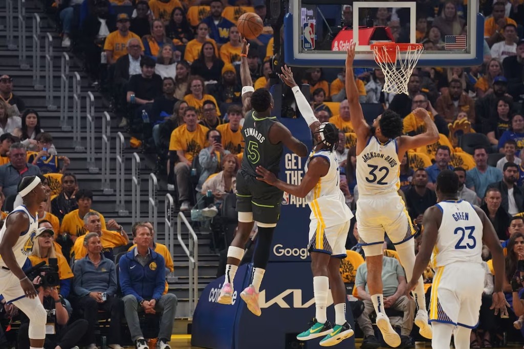 Minnesota Timberwolves guard Anthony Edwards (5) shoots over Golden State Warriors guard Buddy Hield (7) and forward Trayce Jackson-Davis (32) in the first quarter during game three. (Reuters)