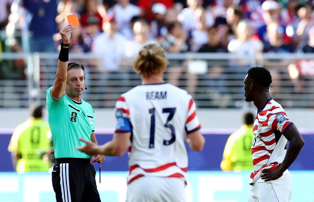 Folarin Balogun of the U.S. is shown a red card by referee Raphael (Reuters)