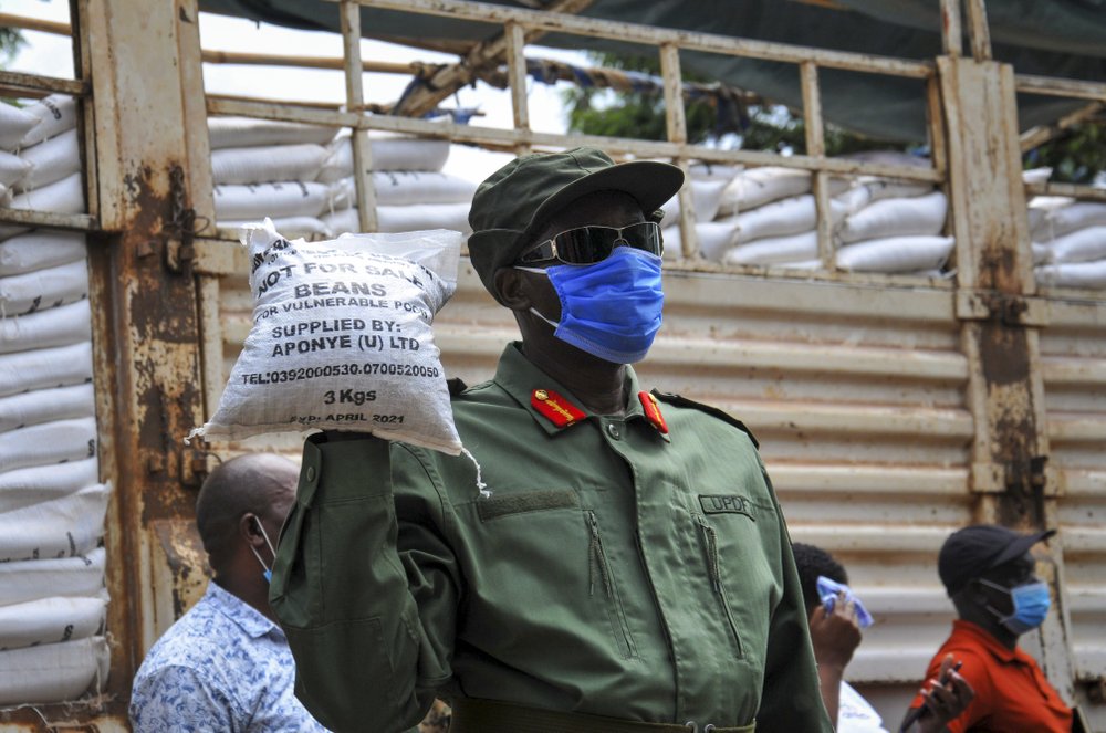On April 4, a member of Uganda's armed forces, the Uganda People's Defence Force, helps to distribute food to people affected by the lockdown, in the Bwaise suburb of the capital Kampala, Uganda. On April 4, a member of Uganda's armed forces, the Uganda People's Defence Force, helps to distribute food to people affected by the lockdown, in the Bwaise suburb of the capital Kampala, Uganda.