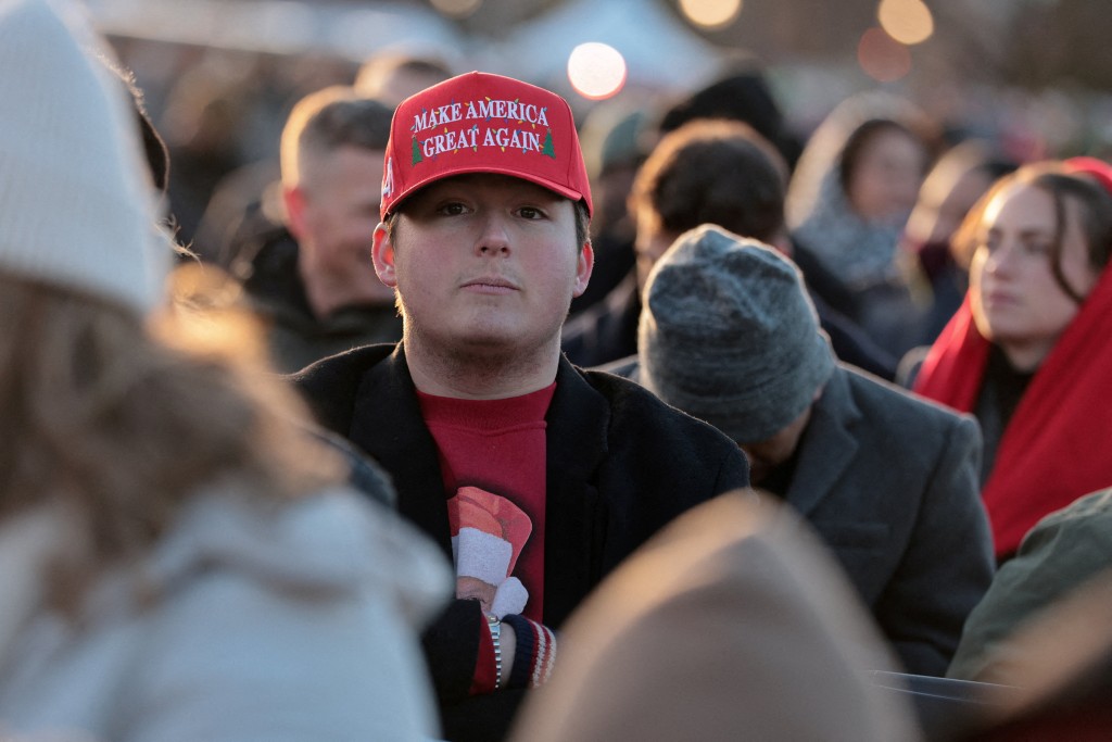 A person wears a Christmas-themed MAGA hat, as people gather near the White House, before U.S. President Donald Trump participates in the 103rd National Christmas Tree Lighting Ceremony in Washington, D.C., U.S., December 4, 2025. REUTERS/Jonathan Ernst