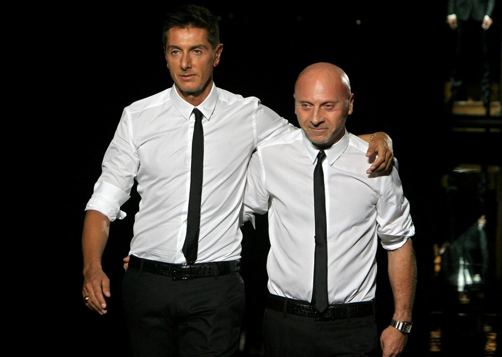 Photo by FILIPPO MONTEFORTE / AFP  Italian fashion designers Domenico Dolce (L) and Stefano Gabbana acknowledge the applause after presenting their Dolce & Gabbana 2008 spring/summer men's collection at Milan's fashion week, 23 June 2007.