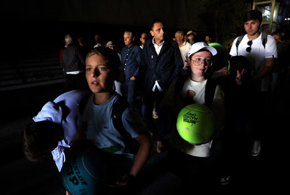 Fans are seen after the matches get suspended due to a power outage. (Reuters)