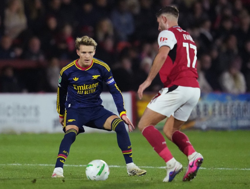 Arsenal's Martin Odegaard in action against Fleetwood Town's Ched Evans. REUTERS 