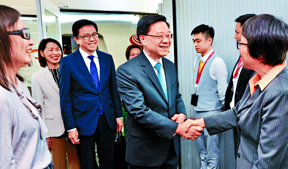 John Lee, seen with Sun Dong, is welcomed to Hainan. John Lee, seen with Sun Dong, is welcomed to Hainan.