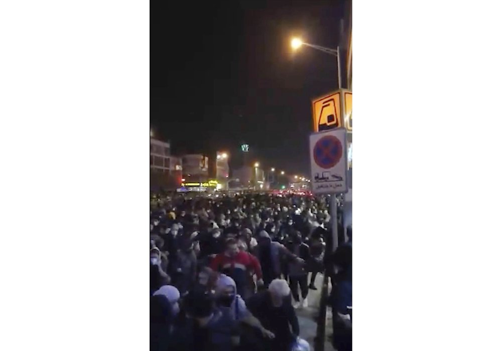 This image from a Sunday, Jan. 12, 2020 video provided by the New York-based Center for Human Rights in Iran shows a crowd fleeing police near Azadi, or Freedom, Square in Tehran, Iran. This image from a Sunday, Jan. 12, 2020 video provided by the New York-based Center for Human Rights in Iran shows a crowd fleeing police near Azadi, or Freedom, Square in Tehran, Iran.