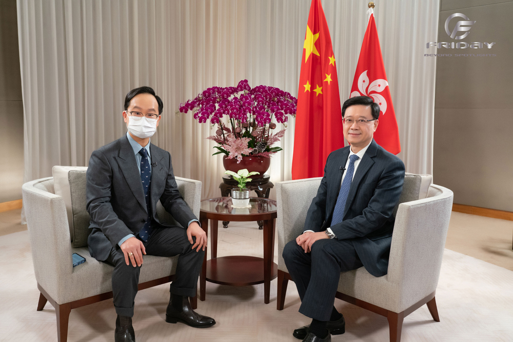 Honorable John Lee (R), the Chief Executive of the Hong Kong SAR with host Patrick Tsang. Honorable John Lee (R), the Chief Executive of the Hong Kong SAR with host Patrick Tsang.
