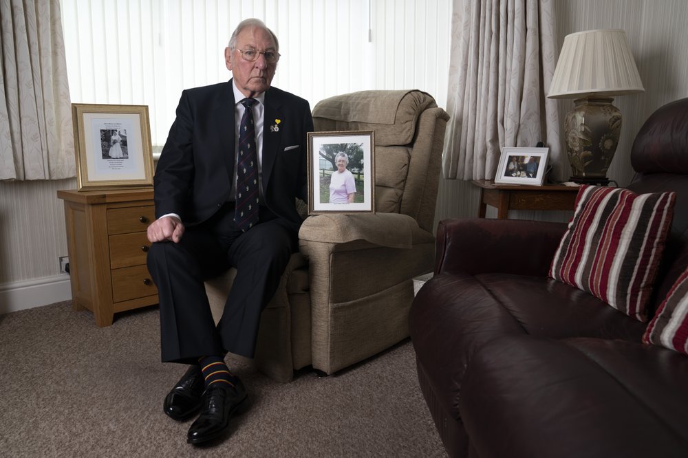 Retired Major Gordon Bonner holds a photograph of his wife Muriel who, in April 2020 died ofthe coronavirus disease at his home in Leeds, England, Saturday Janaury 23, 2021. Bonner has been in the 'hinterlands of despair and desolation' after losing Muriel, his wife of 63 years, to the coronavirus pandemic that has now taken the lives of more than 100,000 people in the United Kingdom. Retired Major Gordon Bonner holds a photograph of his wife Muriel who, in April 2020 died ofthe coronavirus disease at his home in Leeds, England, Saturday Janaury 23, 2021. Bonner has been in the 'hinterlands of despair and desolation' after losing Muriel, his wife of 63 years, to the coronavirus pandemic that has now taken the lives of more than 100,000 people in the United Kingdom.
