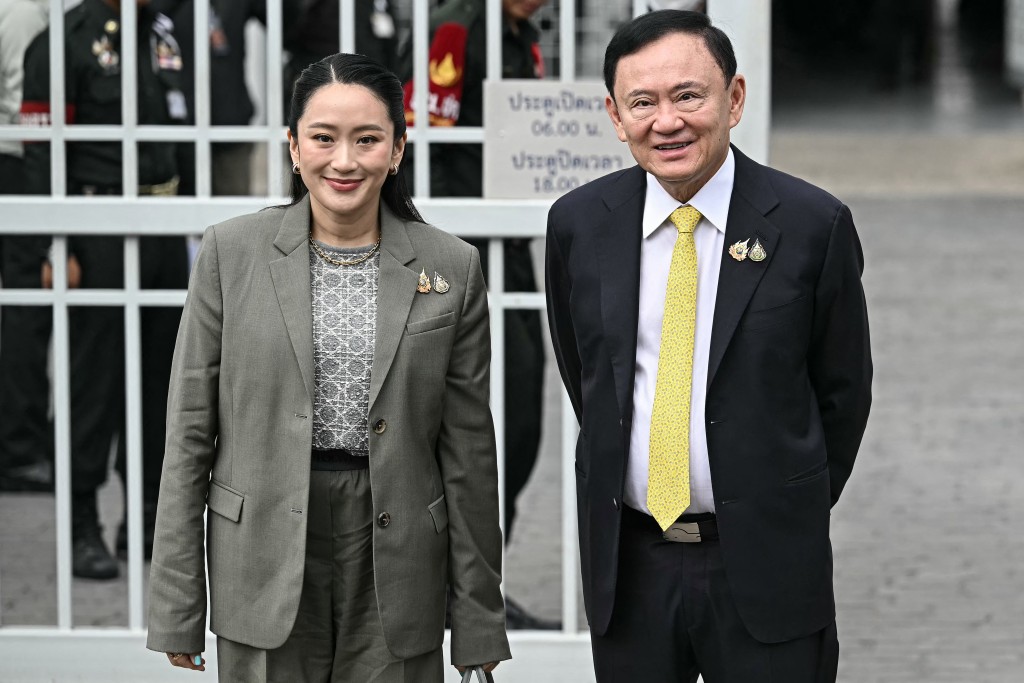 Photo by LILLIAN SUWANRUMPHA / AFP  Thailand's former Prime Minister Thaksin Shinawatra poses with his daughter Thailand's sacked prime minister Paetongtarn Shinawatra as they arrive at the Supreme Court in Bangkok on September 9, 2025, ahead of a ruling on whether he properly served a prison term in 2023.