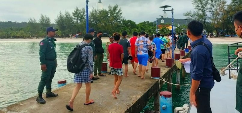 Chinese nationals walk on a pier at an island in Preah Sihanouk Province, southwestern Cambodia, after they were rescued from a ship sinking. (AP) Chinese nationals walk on a pier at an island in Preah Sihanouk Province, southwestern Cambodia, after they were rescued from a ship sinking. (AP)