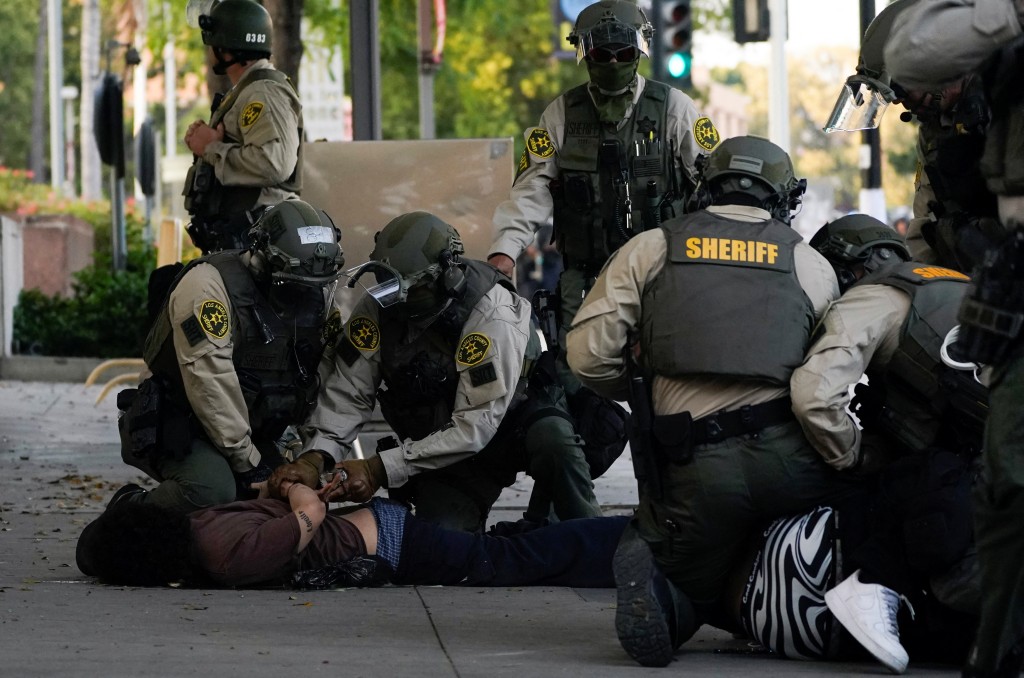 Members of law enforcement detain a person as people protest against federal immigration sweeps, in downtown Los Angeles, California, U.S. June 11, 2025. (Reuters)