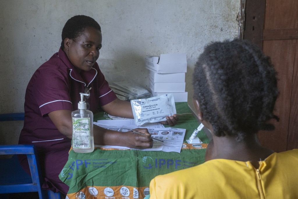 Photo by AMOS GUMULIRA / AFP  Community Midwife Assistant Eluby Gwala (L), who is an HIV Testing Services Provider from Ukwe Health centre in Lilongwe, teaches a client how to use the HIV self-test kit at the Mphetsankhuli outreach clinic in Lilongwe on January 19, 2026.