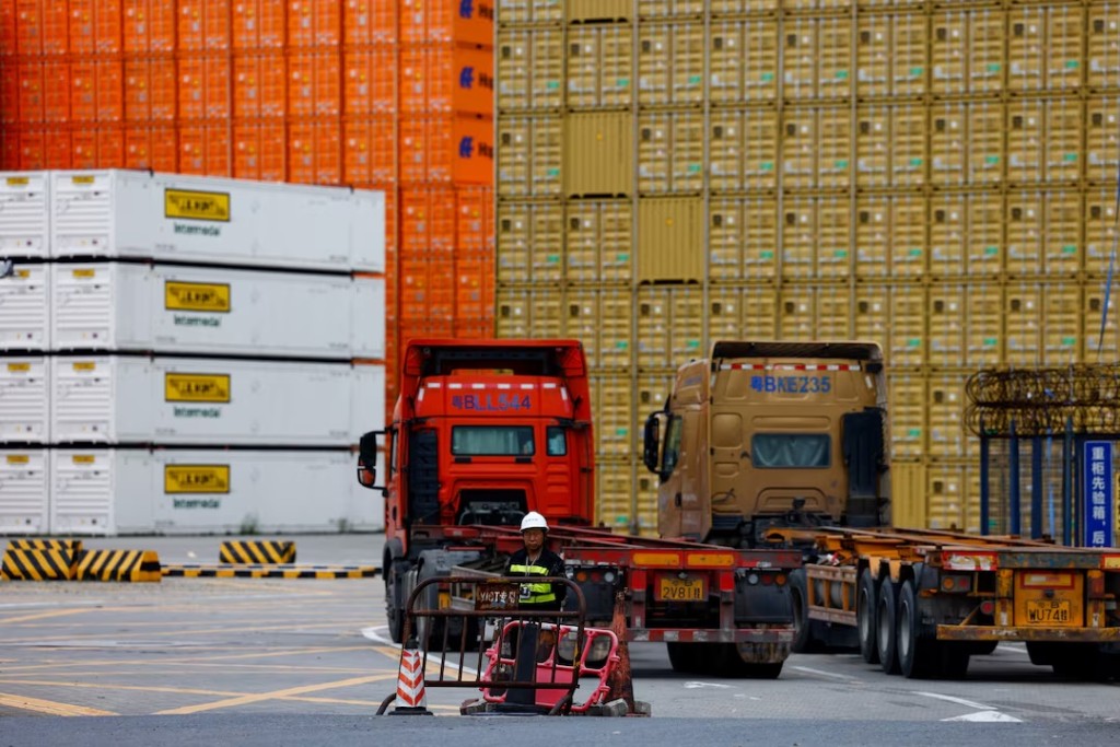 A security personnel stands guard at an entrance to a container logistics centre at the Yantian port in Shenzhen, Guangdong province, China May 9, 2025. REUTERS/Tingshu Wang/File Photo