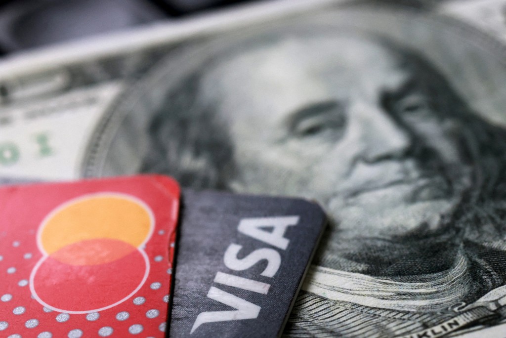 U.S. dollar banknote, Visa and Mastercard cards in this illustration taken September 24, 2025. REUTERS