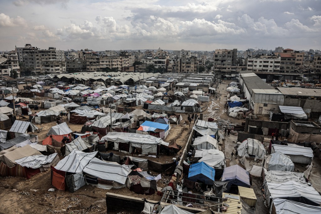 Photo by OMAR AL-QATTAA / AFP  A photograph shows a displacement camp in Gaza City on November 14, 2025.