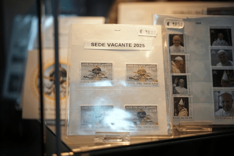 A series of 2025 Vatican Vacant Seat stamps are on display in the Filitalia stamps, coins, and souvenirs shop next to the Vatican walls, in Rome, Tuesday, April 29, 2025. (AP Photo/Andrew Medichini)