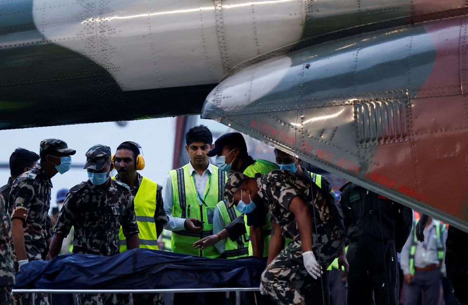 Member of Nepal Army carries the body of a victim of the Tara Air passenger plane, that crashed with 22 people on board. (AP) Member of Nepal Army carries the body of a victim of the Tara Air passenger plane, that crashed with 22 people on board. (AP)