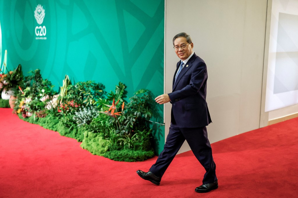 China’s Premier Li Qiang arrives for the second day of the G20 Leaders' Summit at the Nasrec Expo Centre in Johannesburg on November 23, 2025. (Reuters)