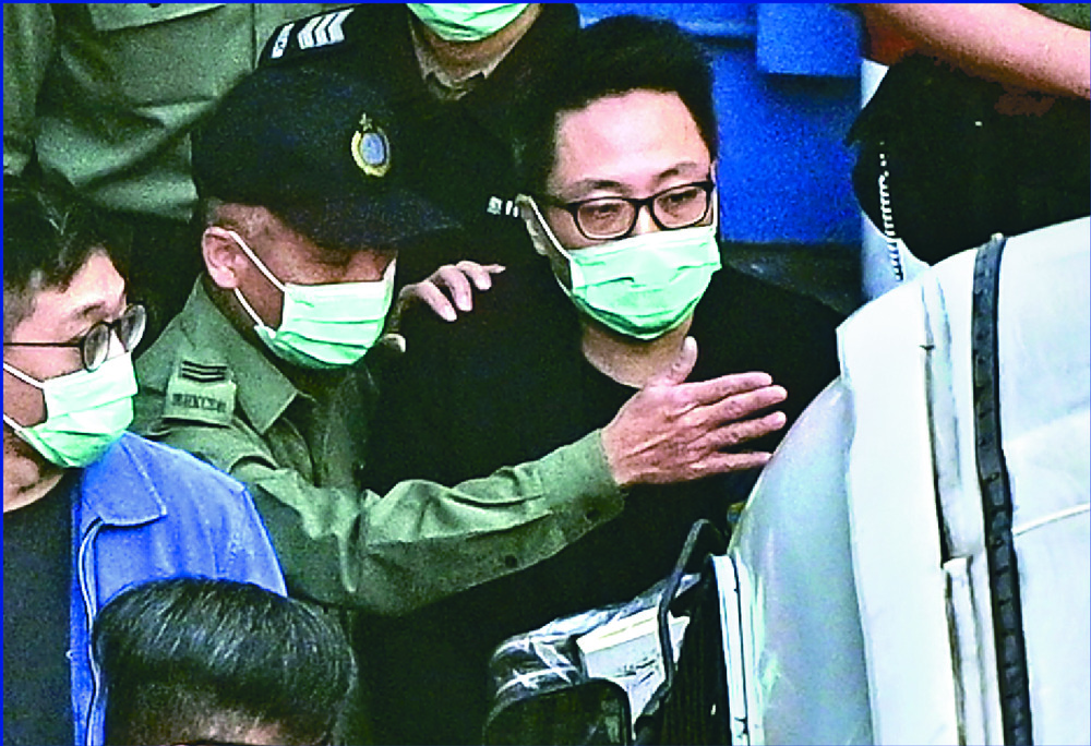 Tam Tak-chi appeared in court yesterday, above, after being arrested for his street booth sessions, left. sing tao Tam Tak-chi appeared in court yesterday, above, after being arrested for his street booth sessions, left. sing tao