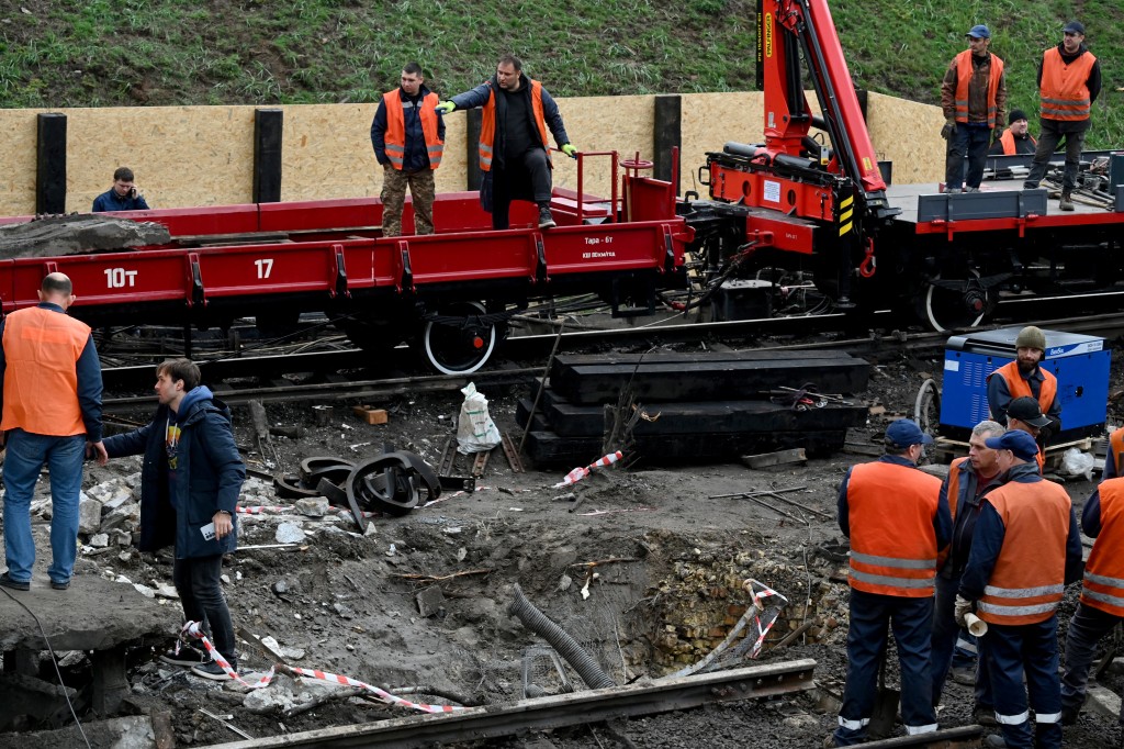 Workers clear the rubble from a metro station following a Russian ballistic missile strike on Kyiv on October 19, 2026, amid the Russian invasion of Ukraine.