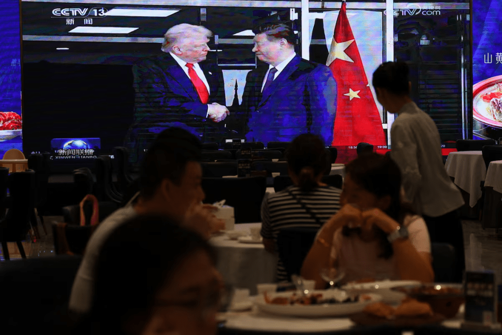 A screen shows news footage of the bilateral meeting between Chinese President Xi Jinping and U.S. President Donald Trump on the sidelines of the Asia-Pacific Economic Cooperation (APEC) summit in South Korea's Busan, at a restaurant in Shenzhen, Guangdong province, China October 30, 2025. REUTERS/Tingshu Wang