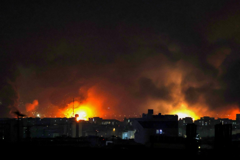 Photo by ATTA KENARE / AFP  Smoke and fire rise from the site of airstrikes at Mehrabad International Airport in Tehran on March 7, 2026.