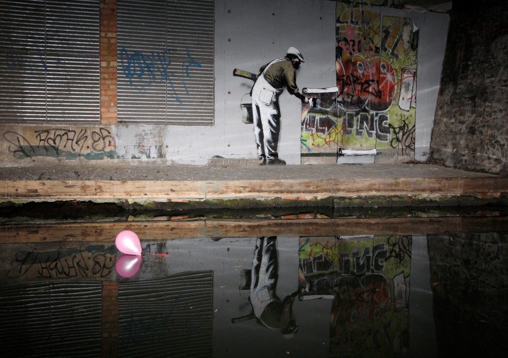  Graffiti art attributed to Banksy is seen on a wall next to the Regent's Canal, in Camden in London December 22, 2009. REUTERS/Luke MacGregor
