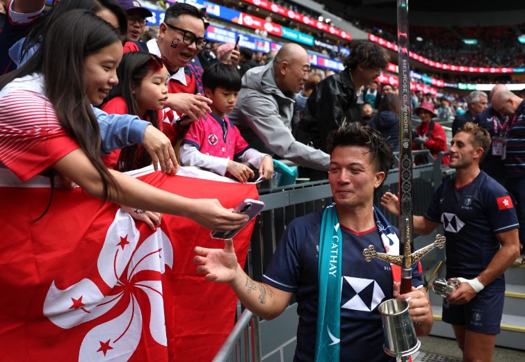 James Christie celebrates with a ceremonial sword after last year’s final win. REUTERS