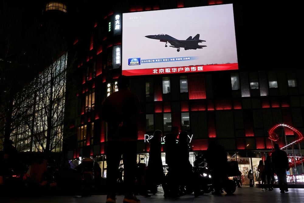 A military aircraft is seen on a giant screen showing news footage about joint army, navy, air and rocket forces drills around Taiwan by the Chinese People's Liberation Army (PLA), outside a shopping mall in Beijing, China, April 1, 2025. (Reuters) A military aircraft is seen on a giant screen showing news footage about joint army, navy, air and rocket forces drills around Taiwan by the Chinese People's Liberation Army (PLA), outside a shopping mall in Beijing, China, April 1, 2025. (Reuters)