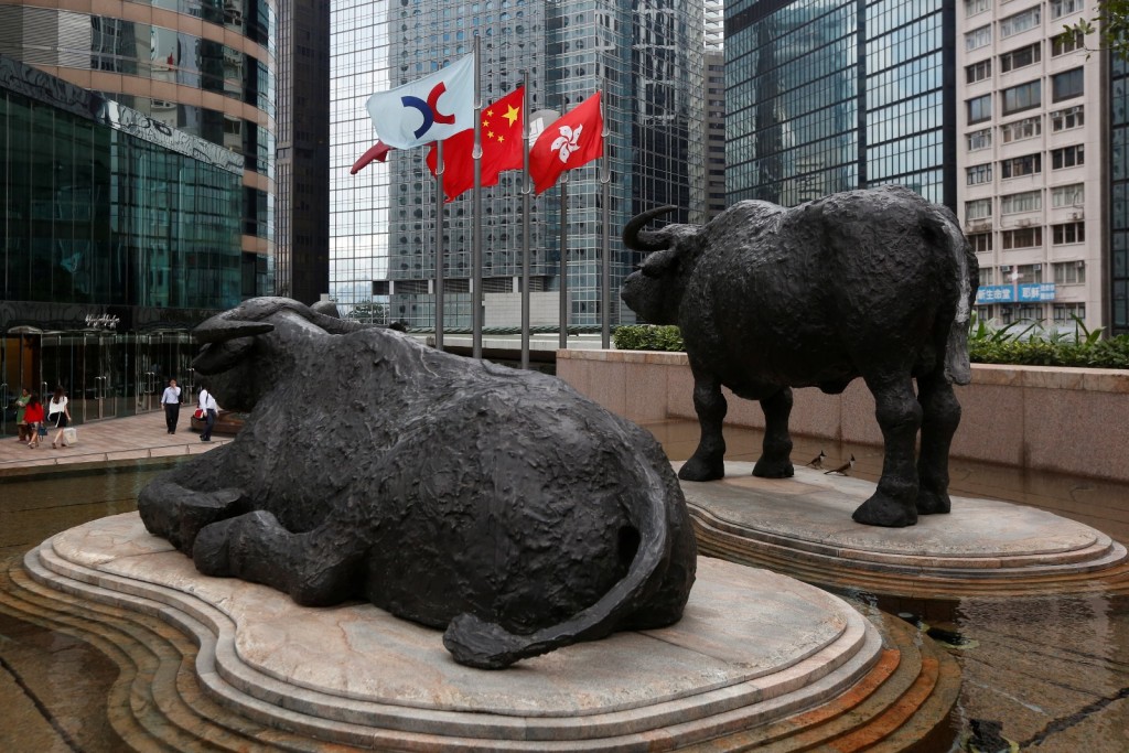 The Hong Kong Exchange flag, Chinese national flag and Hong Kong flag are hoisted outside the Hong Kong Stocks Exchange in Hong Kong. REUTERS