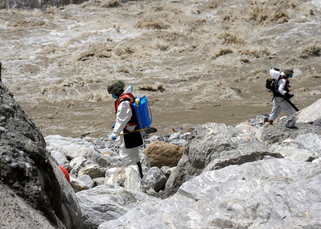 Members of a medical and epidemic prevention unit under the Chinese People's Liberation Army (PLA) disinfect the disaster-hit area of Gyirong Port amid rescue efforts following a mudslide, in Shigatse, Tibet Autonomous Region, China September 3, 2026. cnsphoto via REUTERS