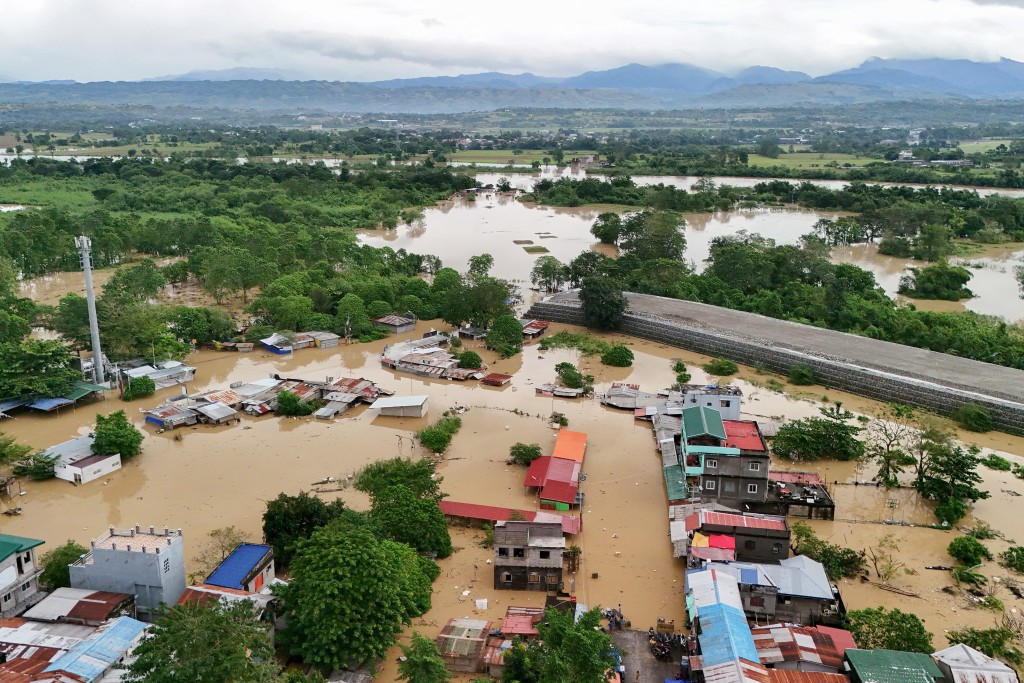 An aerial view of flooded houses in Tuguegarao City, Cagayan province, north of Manila on November 10, 2025, after a river overflowed following heavy rains brought about by Super Typhoon Fung-wong. (AFP)