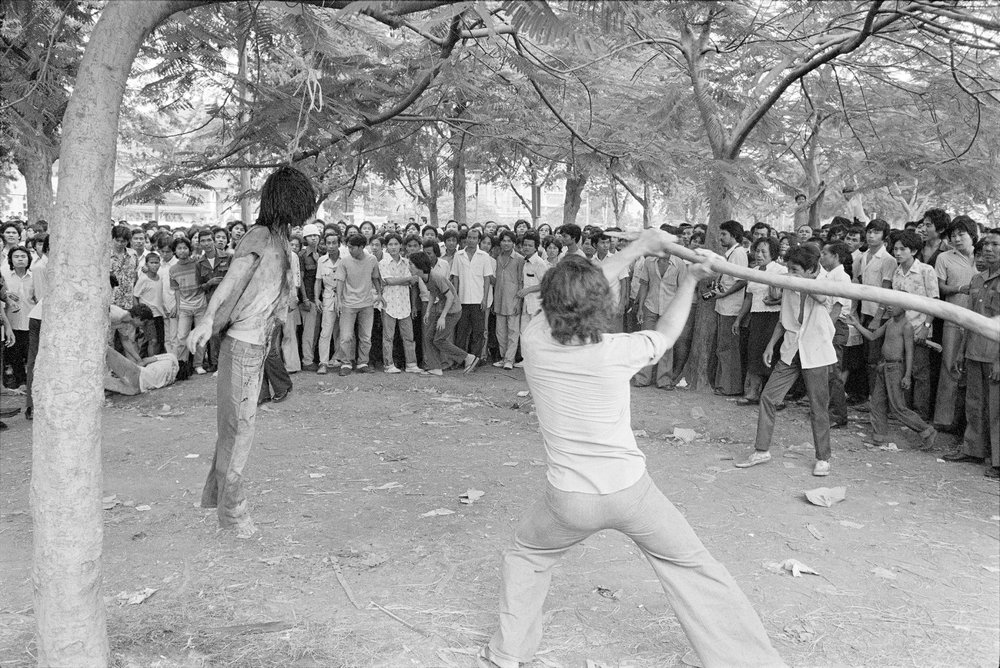 In this October 6, 1976, file photo, a member of a Thai political faction strikes at the lifeless body of a hanged student during a student massacre outside Thammasat University in Bangkok. In this October 6, 1976, file photo, a member of a Thai political faction strikes at the lifeless body of a hanged student during a student massacre outside Thammasat University in Bangkok.