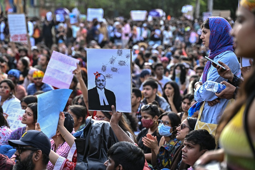 People hold placards during a victory gathering organised by the All India Students' Association (AISA) in Bengaluru on July 26, 2026 a day after the Cockroach Janta Party (CJP) ended their protest in New Delhi's Jantar Mantar following the resignation of India's Education Minister Dharmendra Pradhan over alleged NEET examination irregularities. (Photo by Idrees MOHAMMED / AFP)