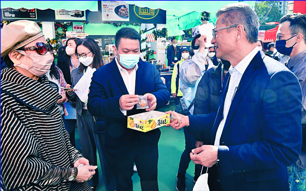 Paul Chan, right, passes samples around. SING TAO Paul Chan, right, passes samples around. SING TAO