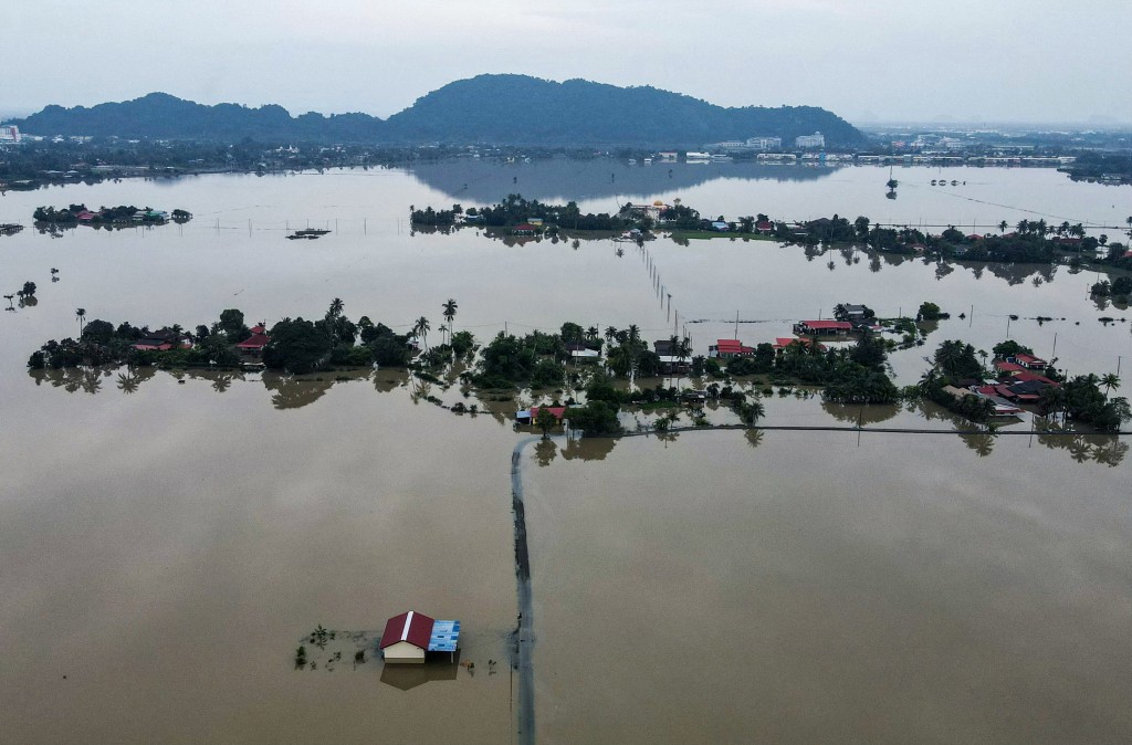 An aerial view shows homes surrounded by flood waters in Kangar in northern Malaysia's Perlis state on November 28. (AFP)