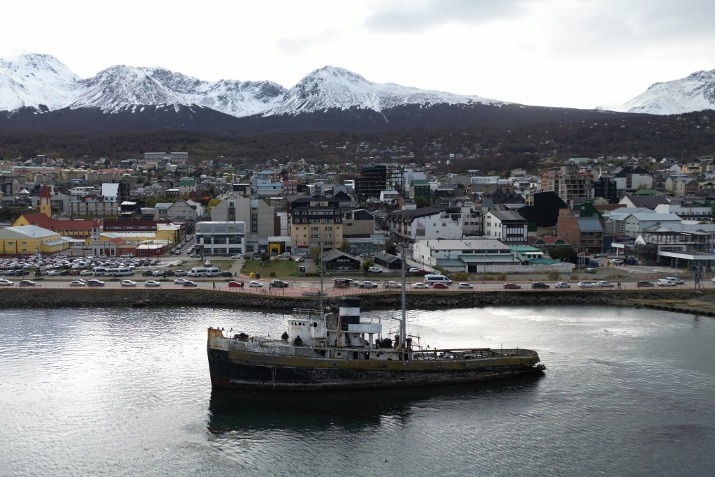 Photo by EDRIEN ESTEVES / AFP  Aerial view of the Saint Christopher tugboat, beached in Ushuaia Bay, near Ushuaia harbour in Tierra del Fuego, Argentina, on May 13, 2026.