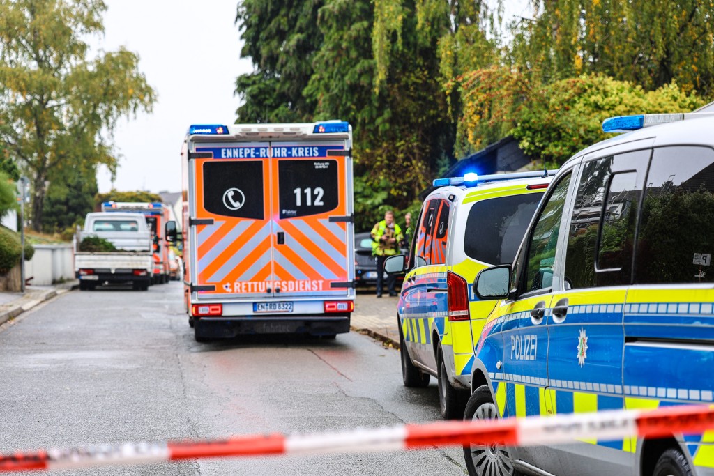 An ambulance and police cars are seen near the site where Iris Stalzer, the newly elected mayor of Herdecke, western Germany, was severely injured in a knife attack, in Herdecke, western Germany on October 7, 2025. (AFP)