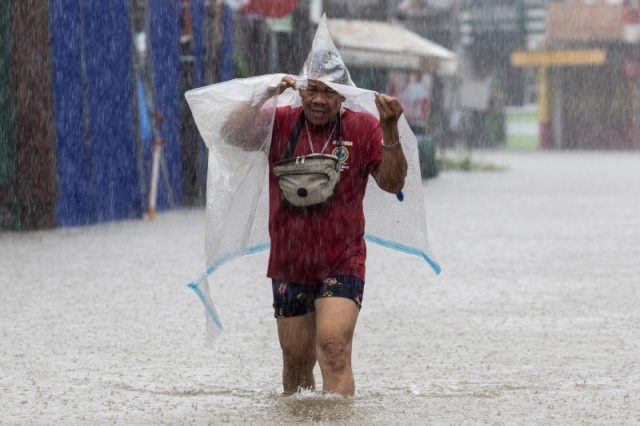 A man wades through a flooded area amid monsoon rains in Cainta, Rizal, Philippines, July 22, 2025. (Reuters/Eloisa Lopez)