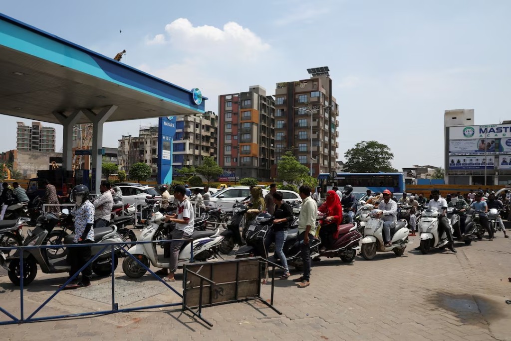 People queue to fill petrol in their two-wheelers with concerns over potential supply disruptions, but authorities say there are no shortages, amid the ongoing U.S.-Israeli conflict with Iran, in Ahmedabad, India, March 24, 2026. REUTERS/Amit Dave/File Photo