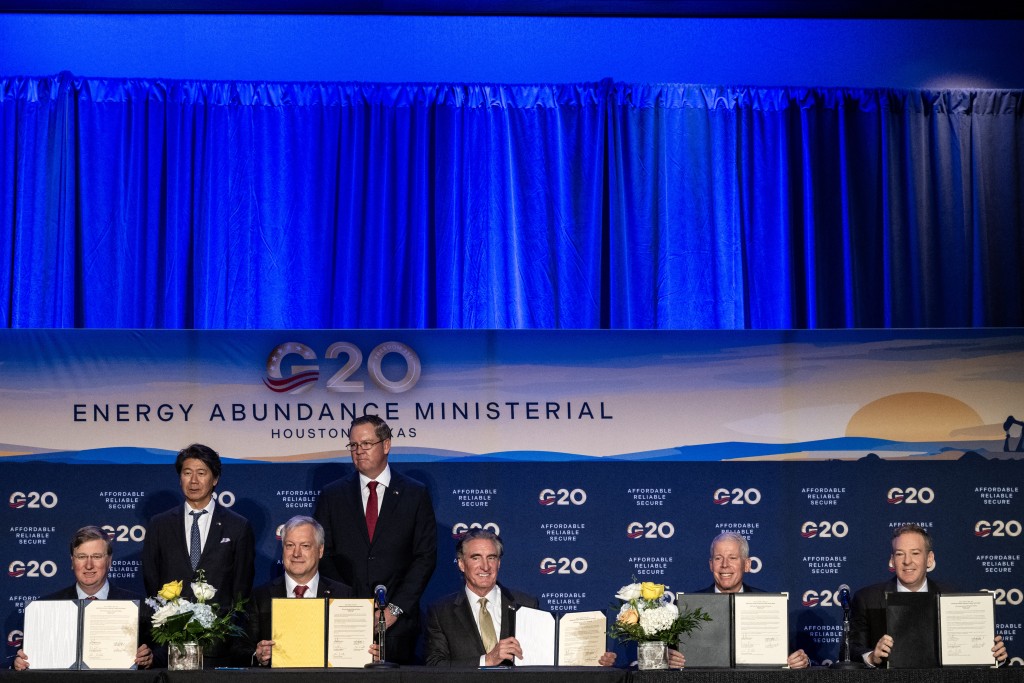 Photo by RONALDO SCHEMIDT / AFP  Mississippi Governor Tate Reeves, Hitachi Energy CEO Andreas Schierenbeck, US Secretary of the Interior Doug Burgum, US Secretary of Energy Chris Wright and EPA Administrator Lee Zeldin show a signed agreement during a joint US-Japan announcement on investments in American manufacturing, during the second day of the G20 Ministerial Meeting on Energy Abundance in Houston, Texas on September 15, 2026.
