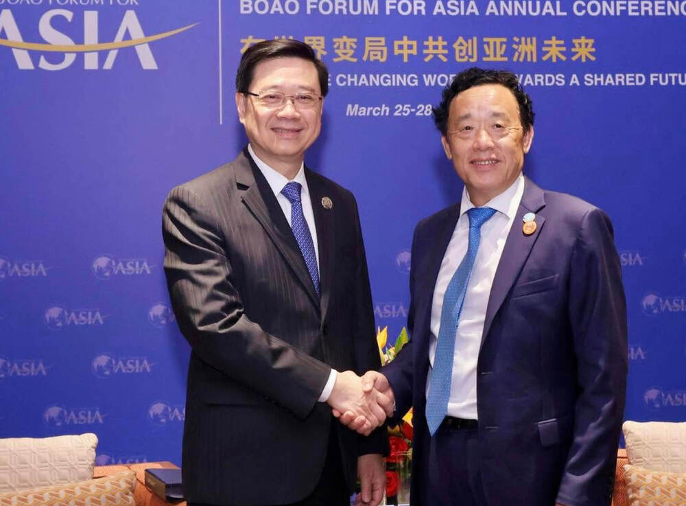 John Lee, left, with Qu Dongyu at the forum. JOHN LEE FB John Lee, left, with Qu Dongyu at the forum. JOHN LEE FB